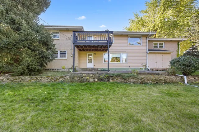 a front view of house with yard and trees