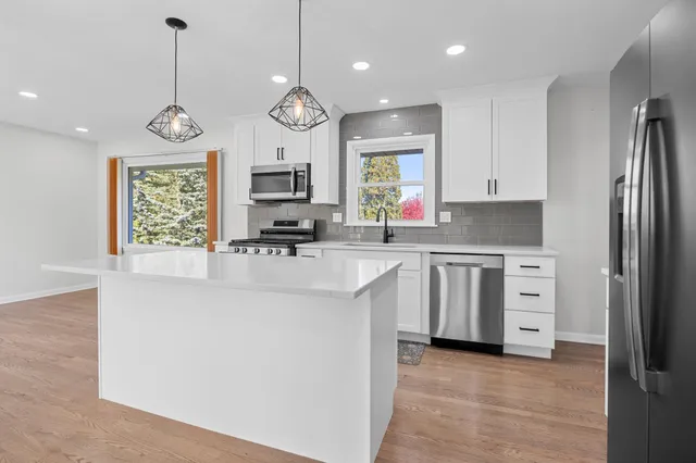 a kitchen with stainless steel appliances a stove oven and a refrigerator