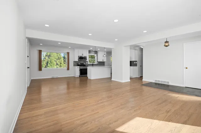 a view of a kitchen with a sink and a window