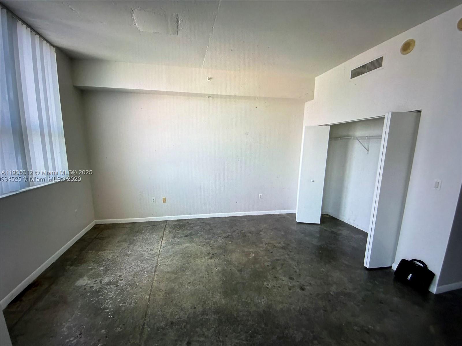 133 Northeast 2nd Avenue, Unit 2611 Miami, FL 33132 - Photo 11 of 15 a view of an empty room with a window