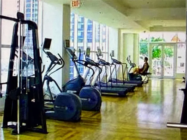a living room with furniture and floor to ceiling window