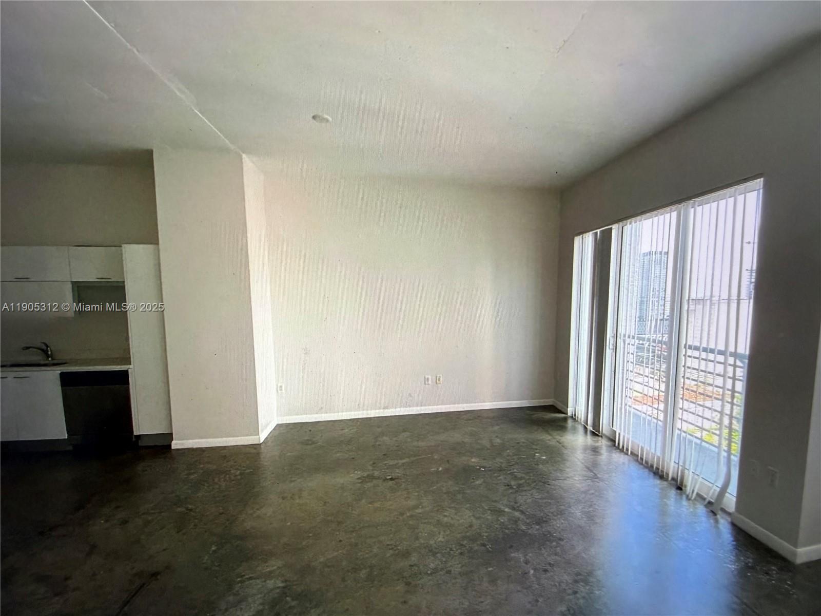 133 Northeast 2nd Avenue, Unit 2611 Miami, FL 33132 - Photo 8 of 15 an empty room with wooden floor and windows