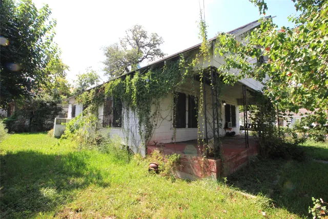 a backyard of a house with yard and outdoor seating
