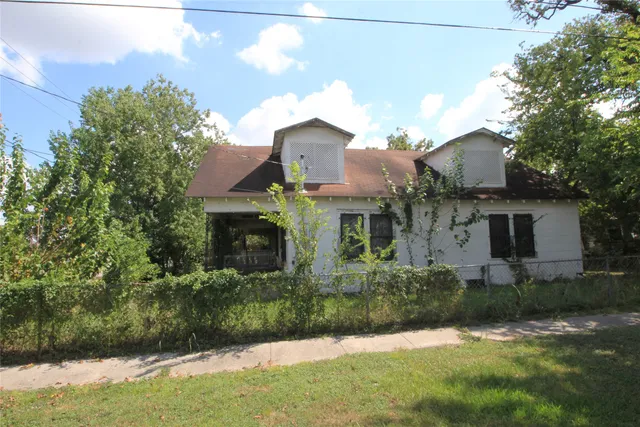 a front view of house with yard and trees
