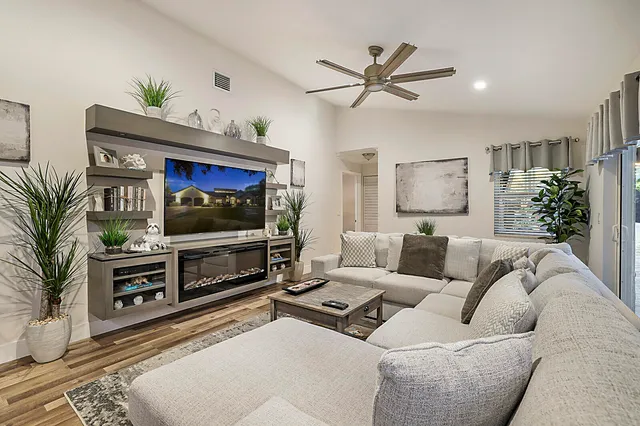 a bathroom with a sink a toilet and large mirror
