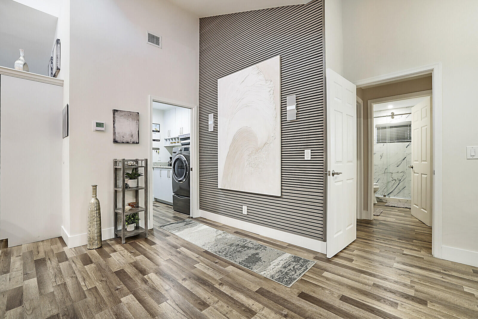 2155 Rabbit Hollowe Circle Delray Beach, FL 33445 - Photo 22 of 71 a view of a hallway with wooden floor and a bathroom