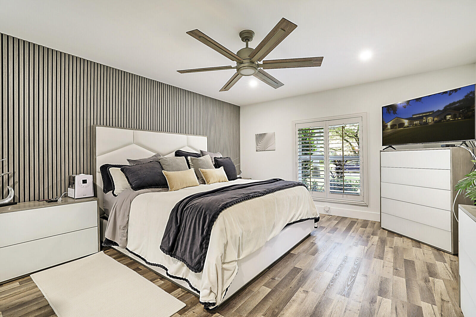 2155 Rabbit Hollowe Circle Delray Beach, FL 33445 - Photo 23 of 71 a bedroom with a bed and a large window