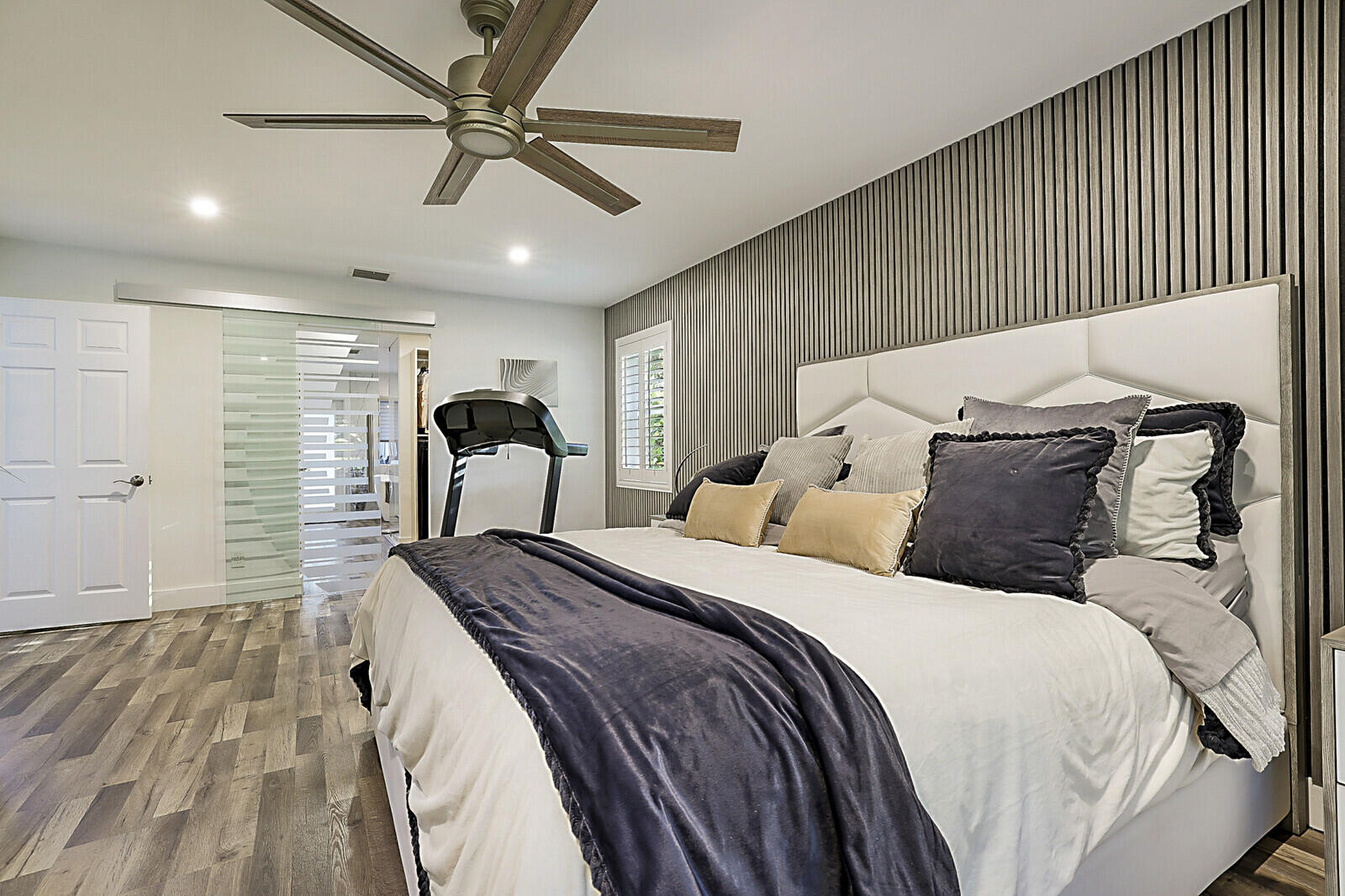 2155 Rabbit Hollowe Circle Delray Beach, FL 33445 - Photo 24 of 71 a bedroom with a bed mirror and on the wall