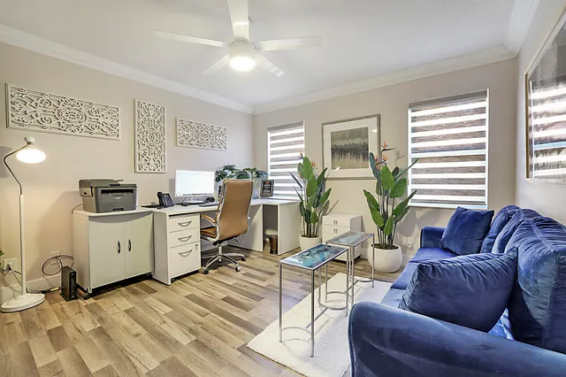 a living room with furniture a window and a table