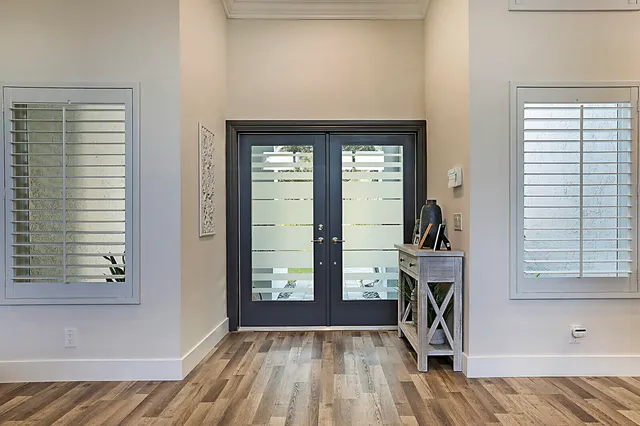 a living room with furniture kitchen view and a large window