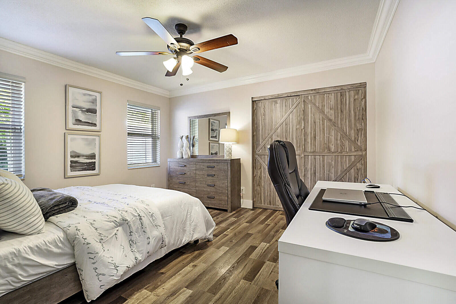 2155 Rabbit Hollowe Circle Delray Beach, FL 33445 - Photo 32 of 71 a bedroom with a bed and a chandelier