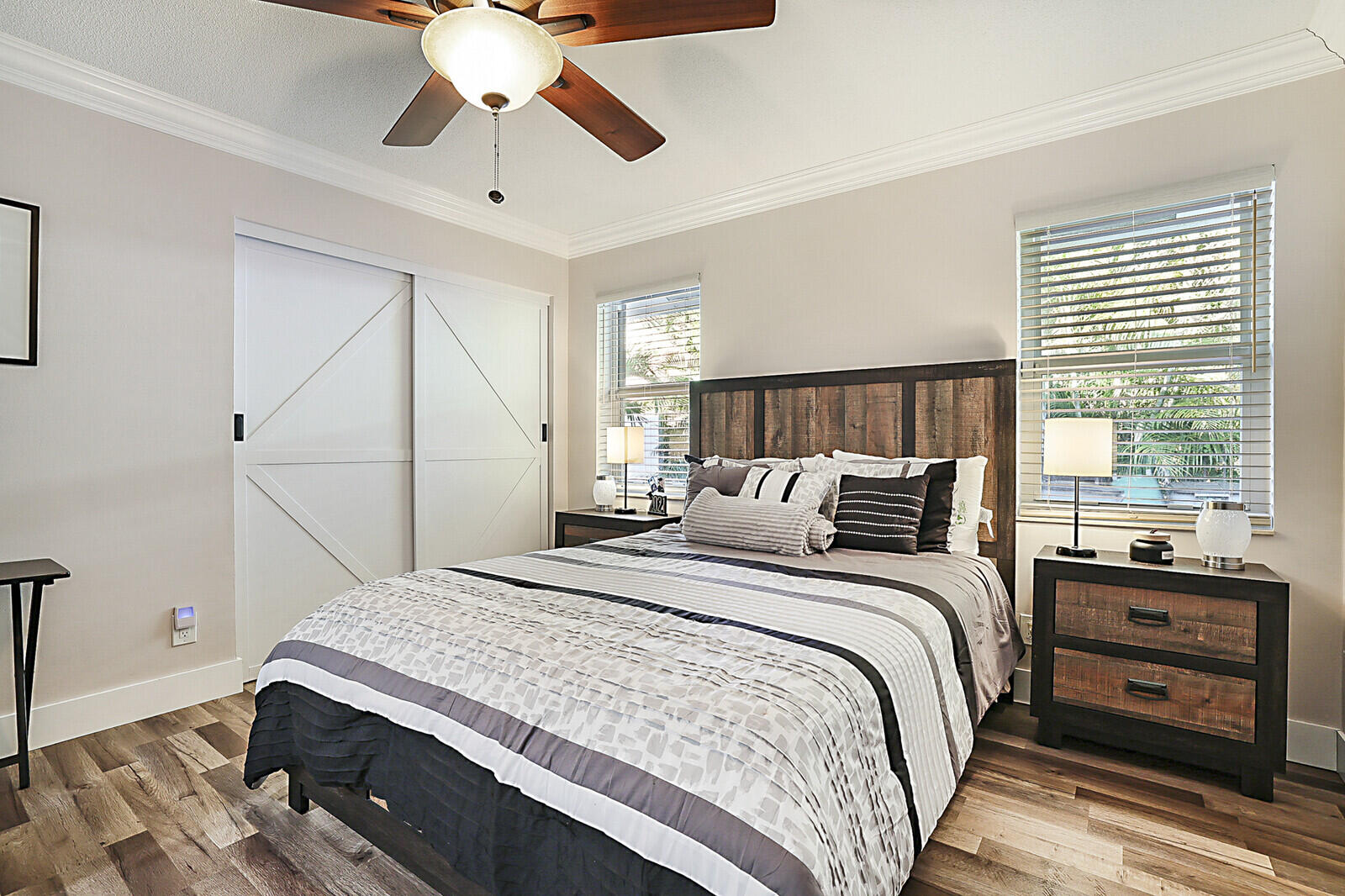 2155 Rabbit Hollowe Circle Delray Beach, FL 33445 - Photo 34 of 71 a bedroom with a bed and a chandelier