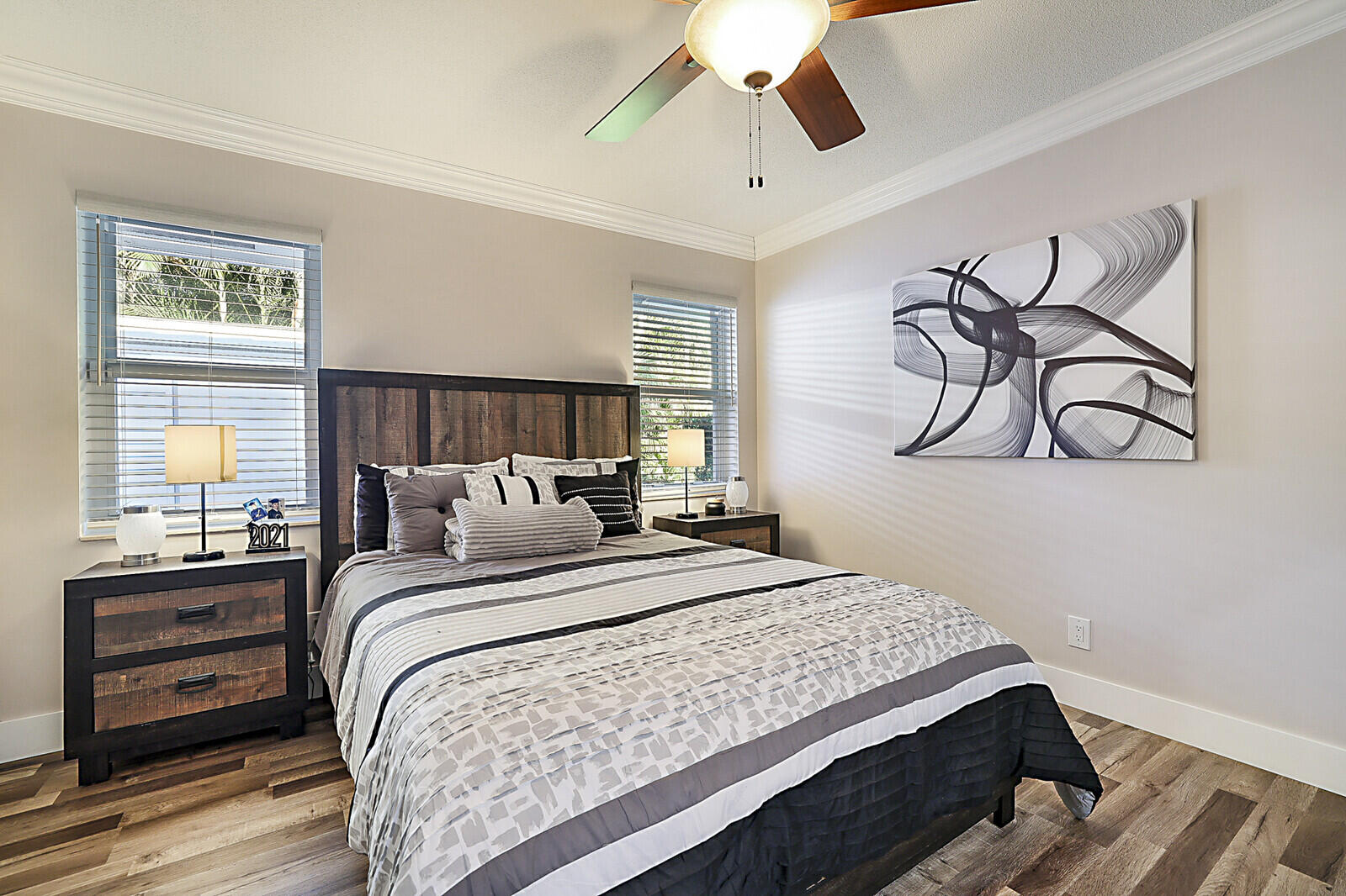 2155 Rabbit Hollowe Circle Delray Beach, FL 33445 - Photo 35 of 71 a bedroom with a bed and wooden floor