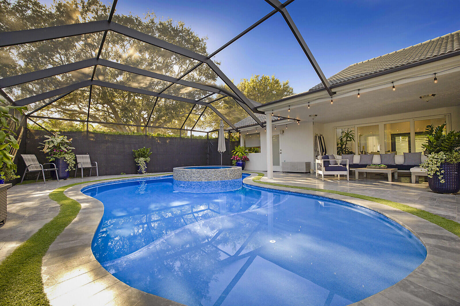 2155 Rabbit Hollowe Circle Delray Beach, FL 33445 - Photo 38 of 71 a view of a swimming pool with a patio