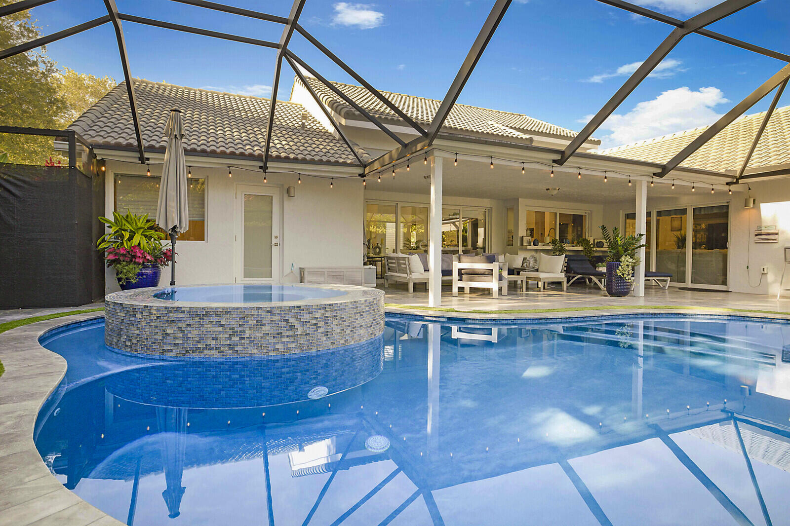 2155 Rabbit Hollowe Circle Delray Beach, FL 33445 - Photo 39 of 71 a living room with furniture and a chandelier