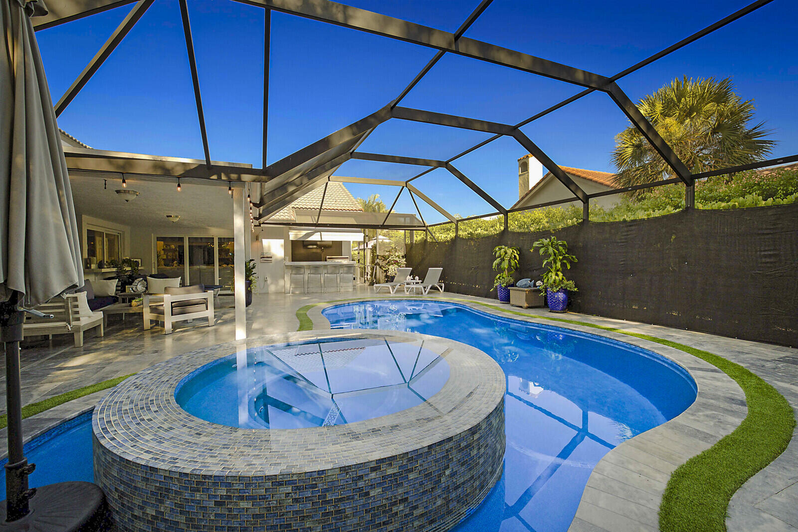 2155 Rabbit Hollowe Circle Delray Beach, FL 33445 - Photo 40 of 71 a view of a swimming pool with a patio