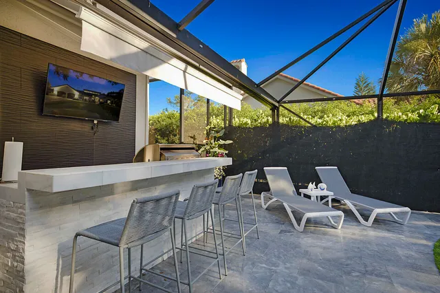 a view of a swimming pool with outdoor seating