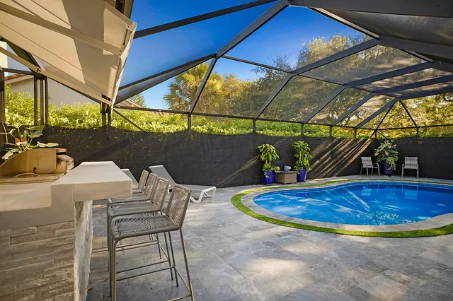 a view of a swimming pool with outdoor seating