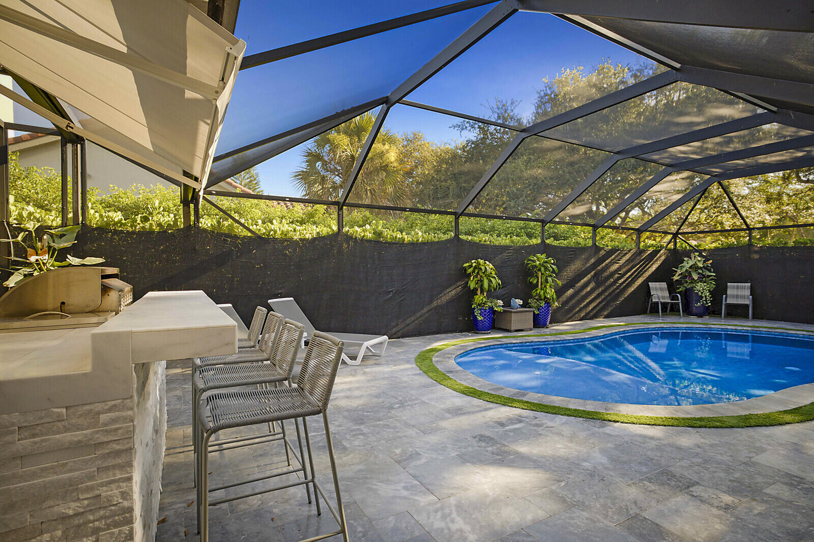 2155 Rabbit Hollowe Circle Delray Beach, FL 33445 - Photo 42 of 71 a view of a swimming pool with a patio