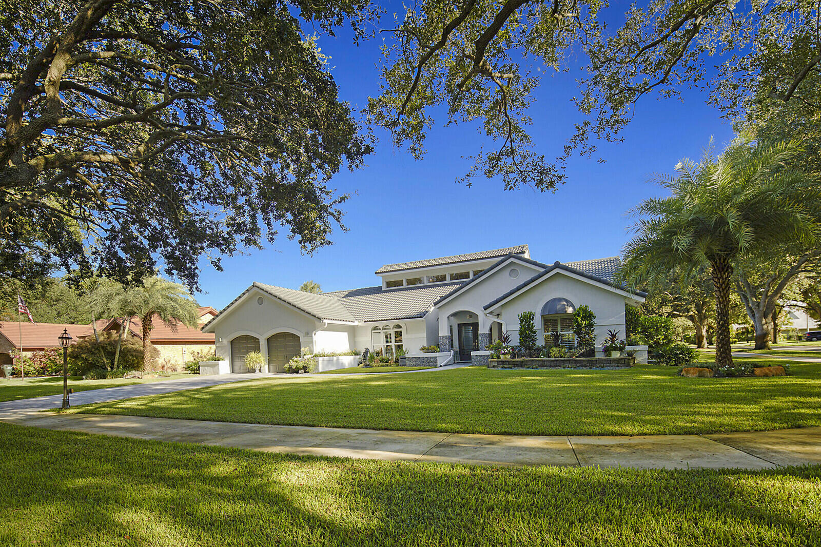 2155 Rabbit Hollowe Circle Delray Beach, FL 33445 - Photo 54 of 71 a view of white and white house with a big yard