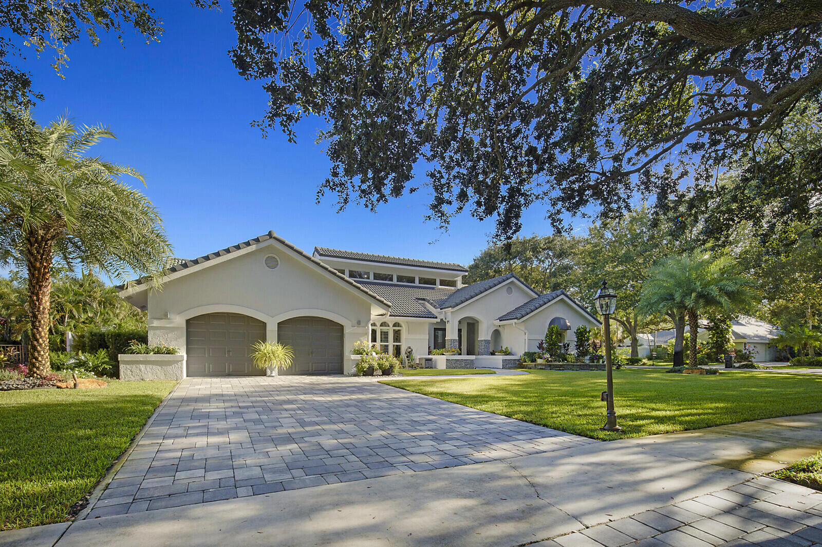 2155 Rabbit Hollowe Circle Delray Beach, FL 33445 - Photo 55 of 71 a front view of a house with a yard
