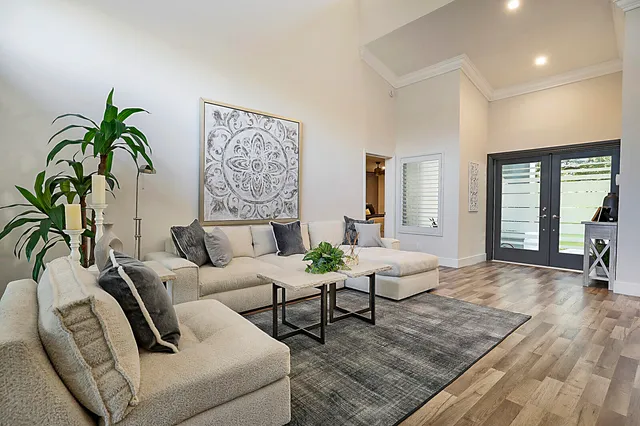 a kitchen with stainless steel appliances kitchen island granite countertop a stove a sink a dining table and chairs with wooden floor