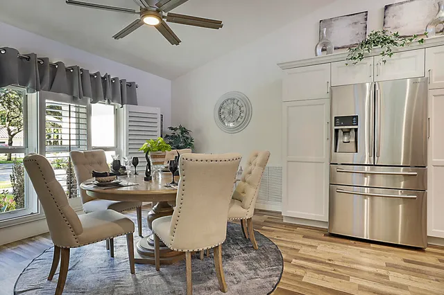 a kitchen with granite countertop white cabinets and white stainless steel appliances