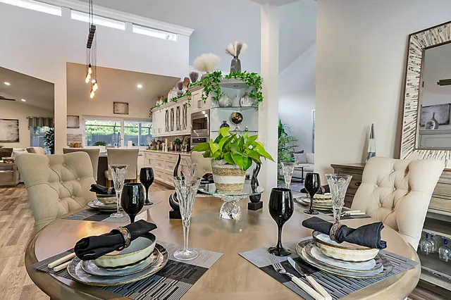 a kitchen with stainless steel appliances granite countertop a sink a stove and a refrigerator