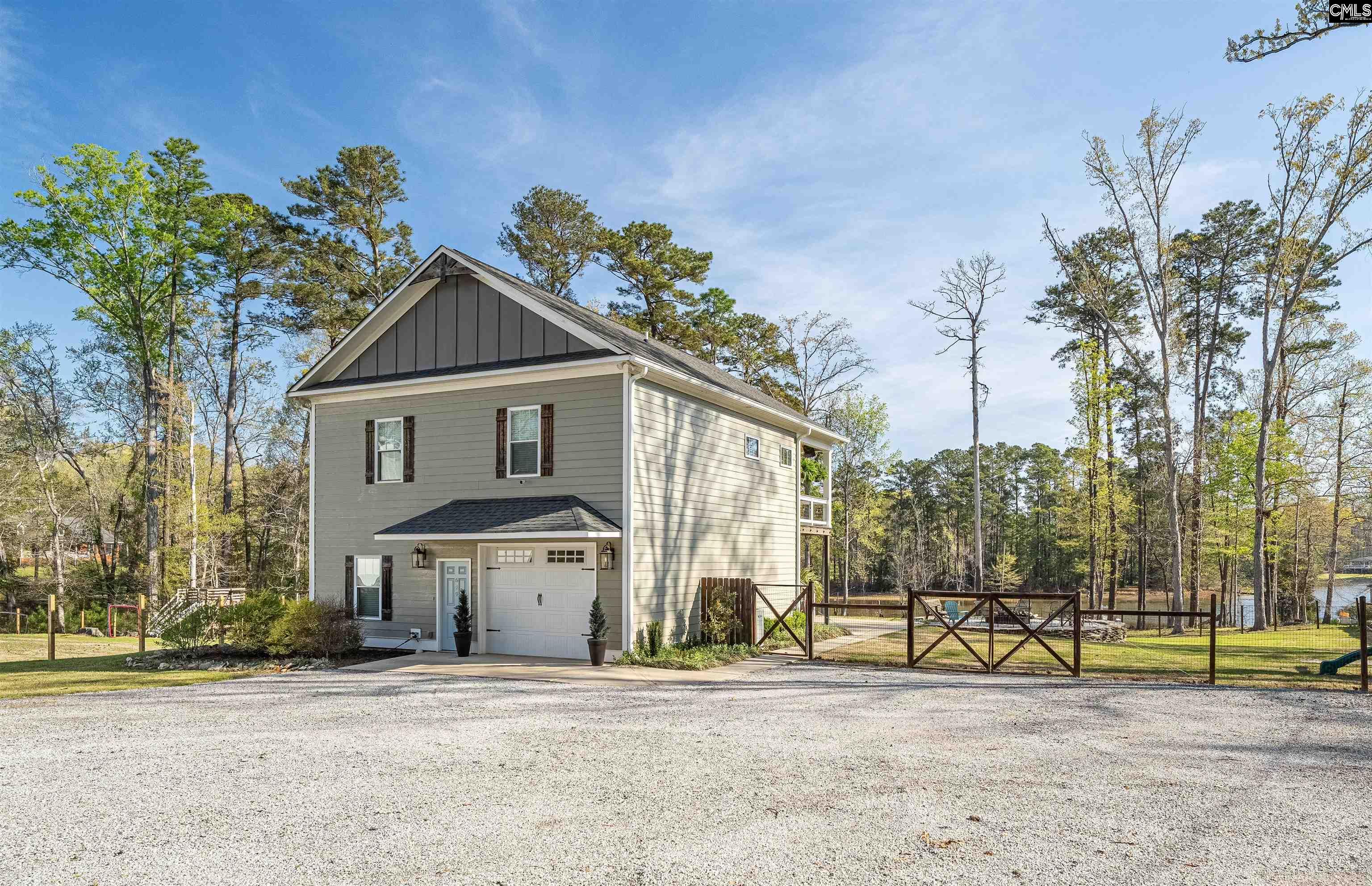 649 Sandbar Road Chapin, SC 29036 - Photo 5 of 40 a front view of a house with a yard and potted plants