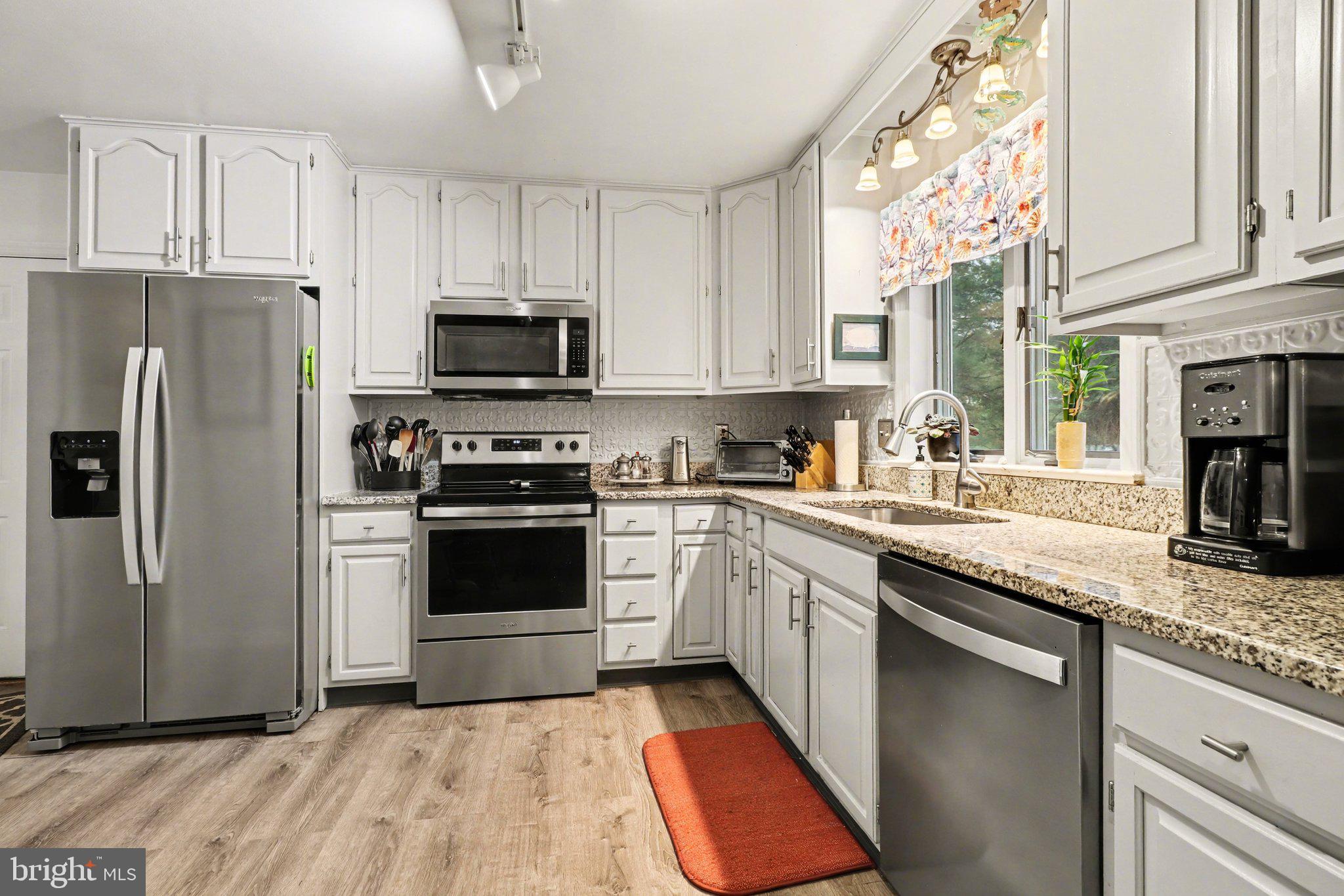 1014 Shadowstone Drive Lancaster, PA 17603 - Photo 11 of 54 a kitchen with granite countertop a refrigerator stove and microwave