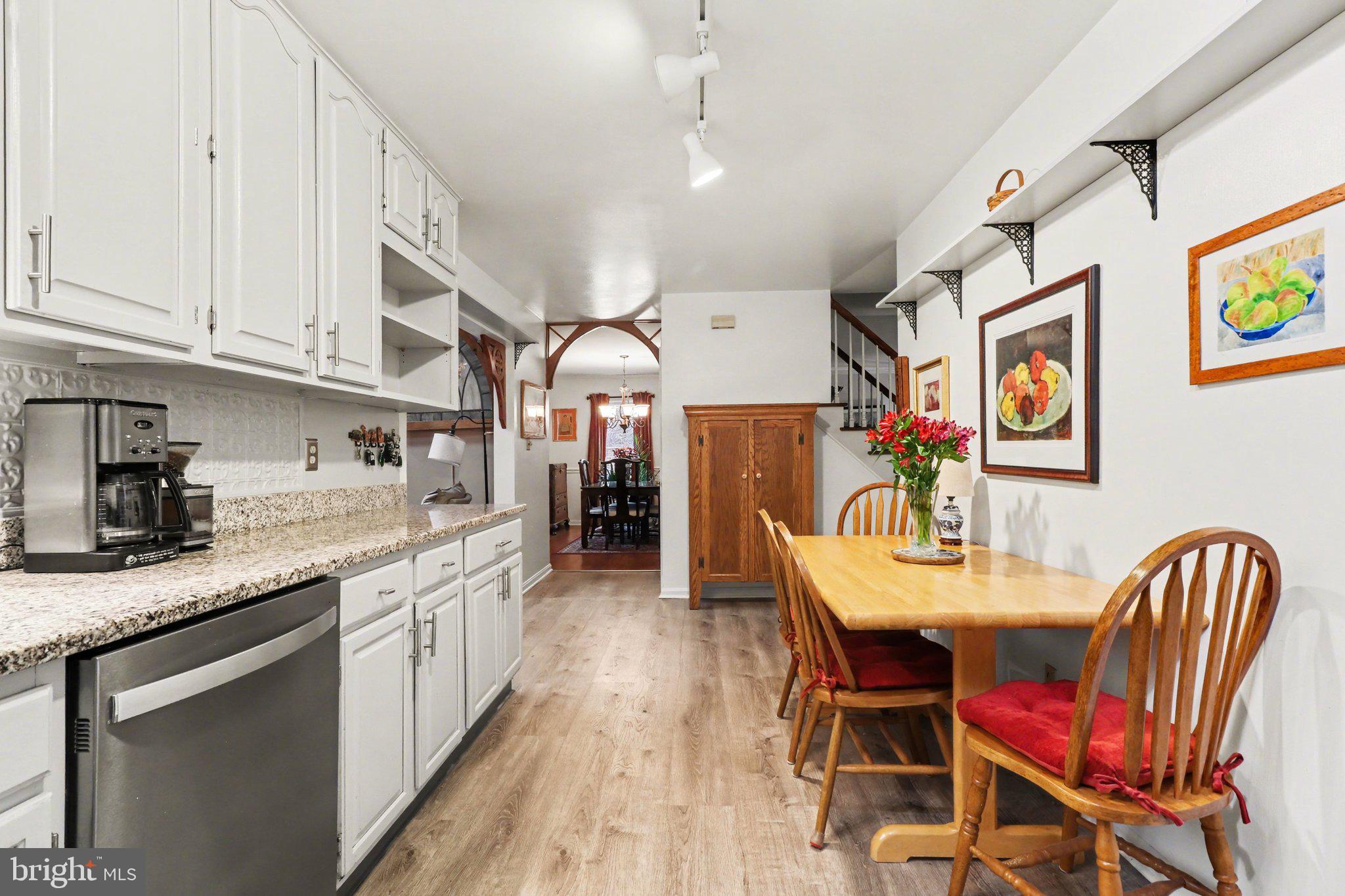 1014 Shadowstone Drive Lancaster, PA 17603 - Photo 12 of 54 a kitchen with stainless steel appliances granite countertop a kitchen island a stove a dining table and chairs with wooden floor