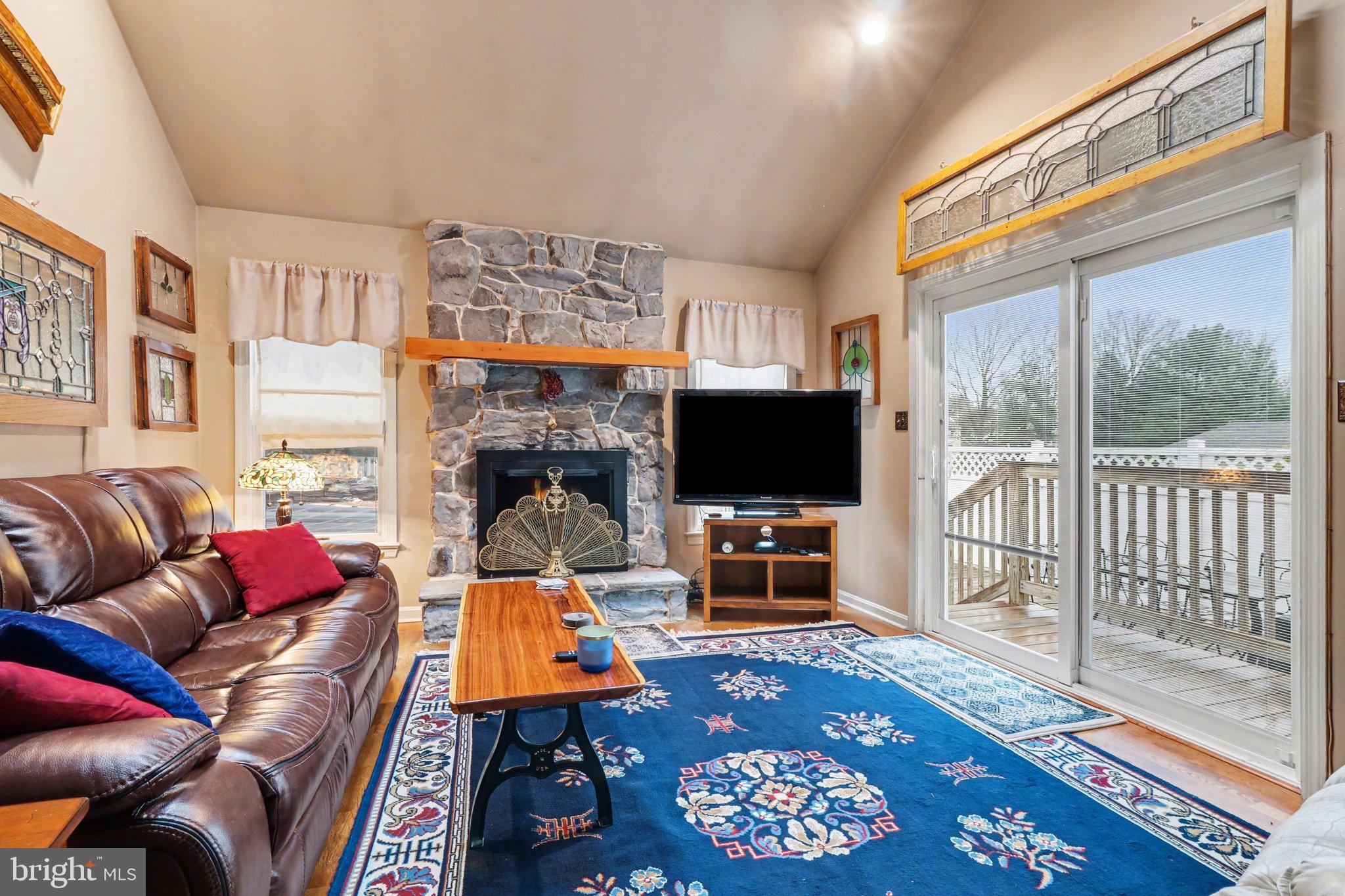 1014 Shadowstone Drive Lancaster, PA 17603 - Photo 15 of 54 a living room with furniture a flat screen tv and a fireplace