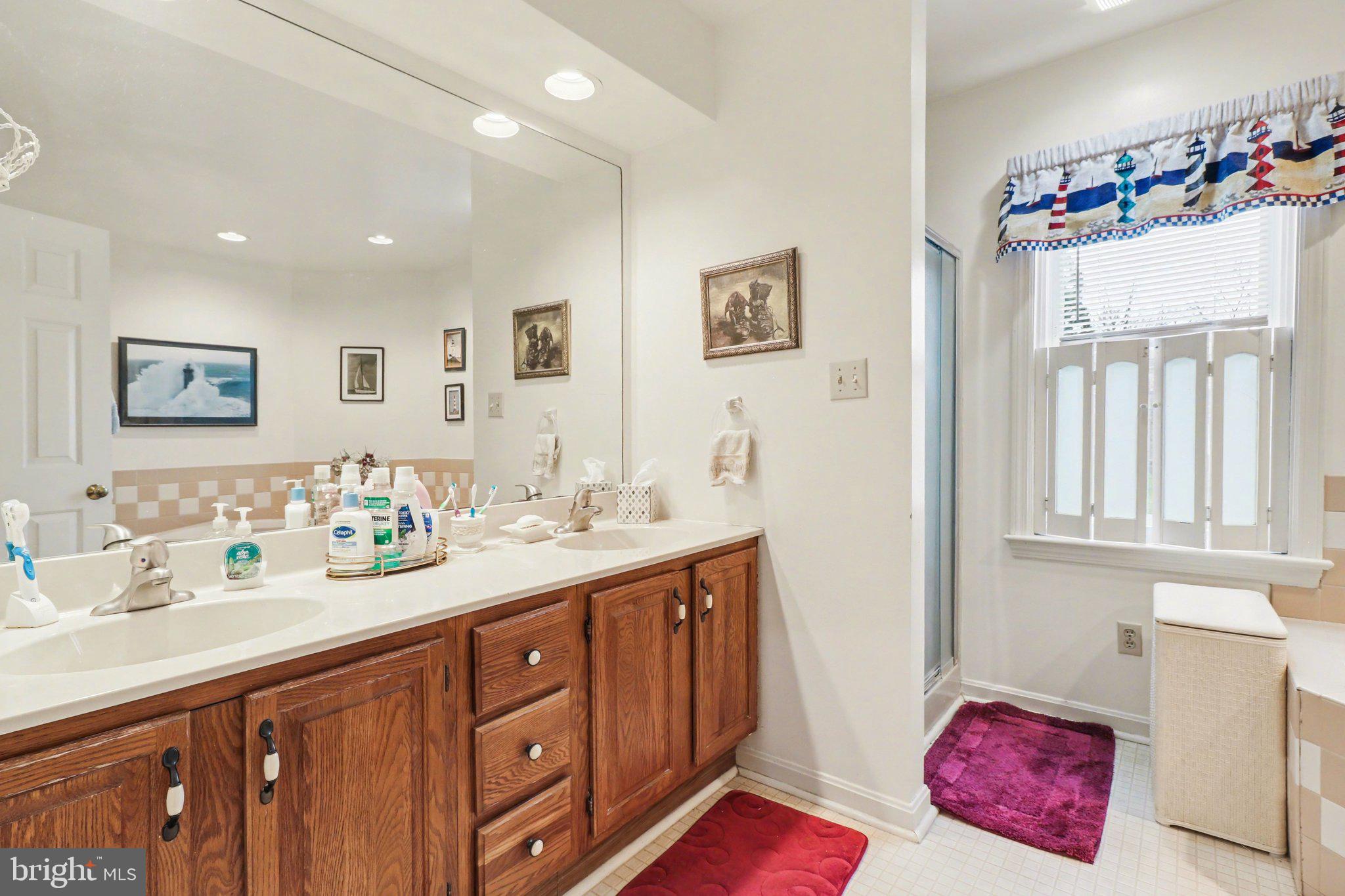 1014 Shadowstone Drive Lancaster, PA 17603 - Photo 34 of 54 a spacious bathroom with double vanity sinks a mirror and a shower