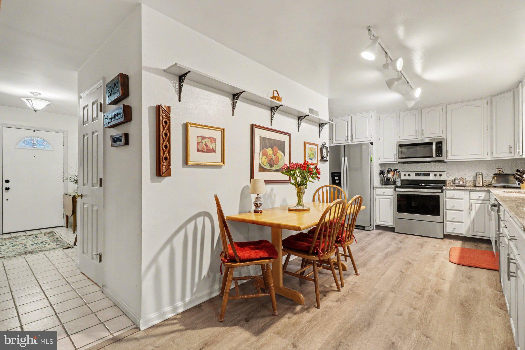 1014 Shadowstone Drive Lancaster, PA 17603 - Photo 10 of 54 a kitchen with stainless steel appliances kitchen island granite countertop a refrigerator a stove a sink dishwasher and white cabinets with wooden floor