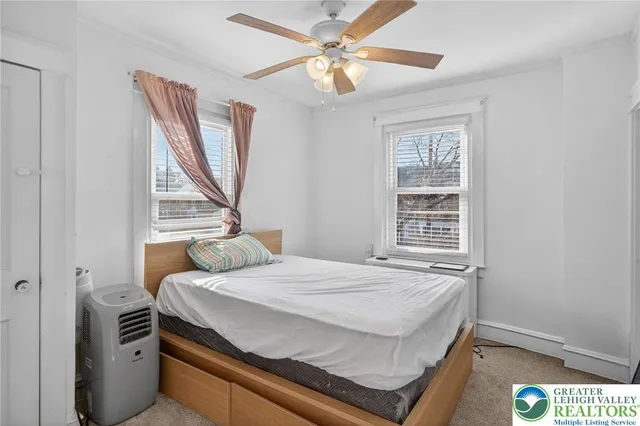 a bedroom with a bed and a window