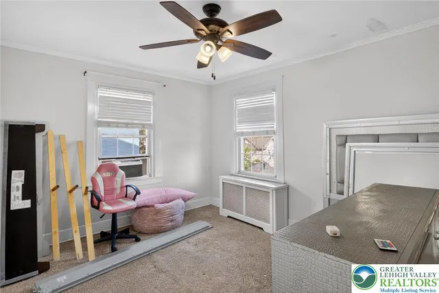 a bedroom with furniture and a window