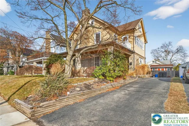 a view of a house with snow on the road