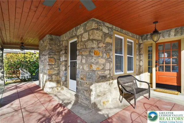 a patio with glass top table and chairs