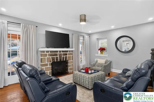 a living room with fireplace furniture and a flat screen tv