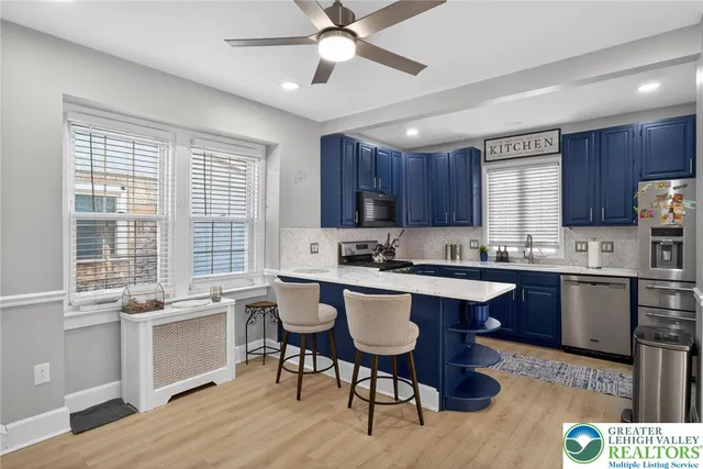 a kitchen with a stove a sink a dining table and chairs