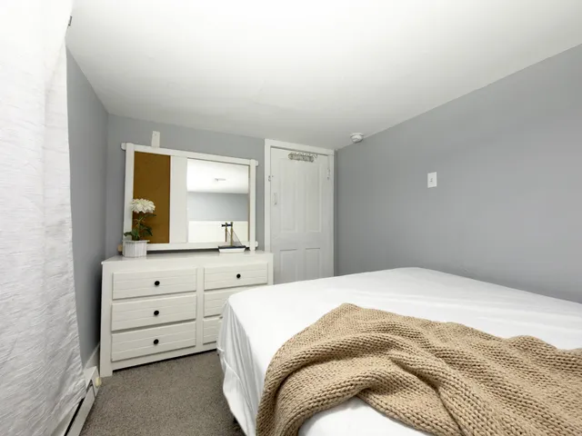 a bedroom with a bed and a dresser