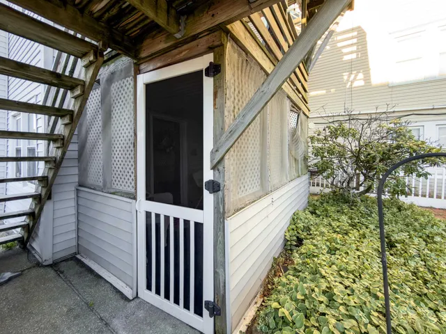 a view of a patio with a table and chairs