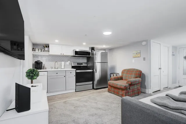 a kitchen with stainless steel appliances kitchen island granite countertop a refrigerator and stove top oven