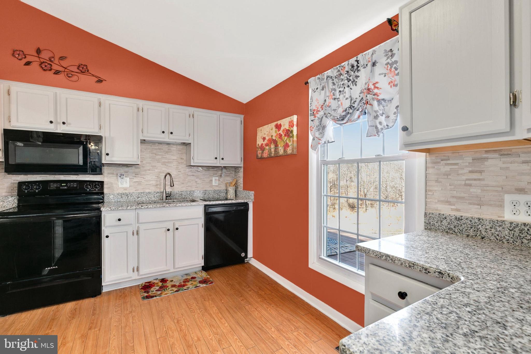 9348 Windbell Way Columbia, MD 21045 - Photo 13 of 37 a kitchen with stainless steel appliances granite countertop a stove a sink and a microwave