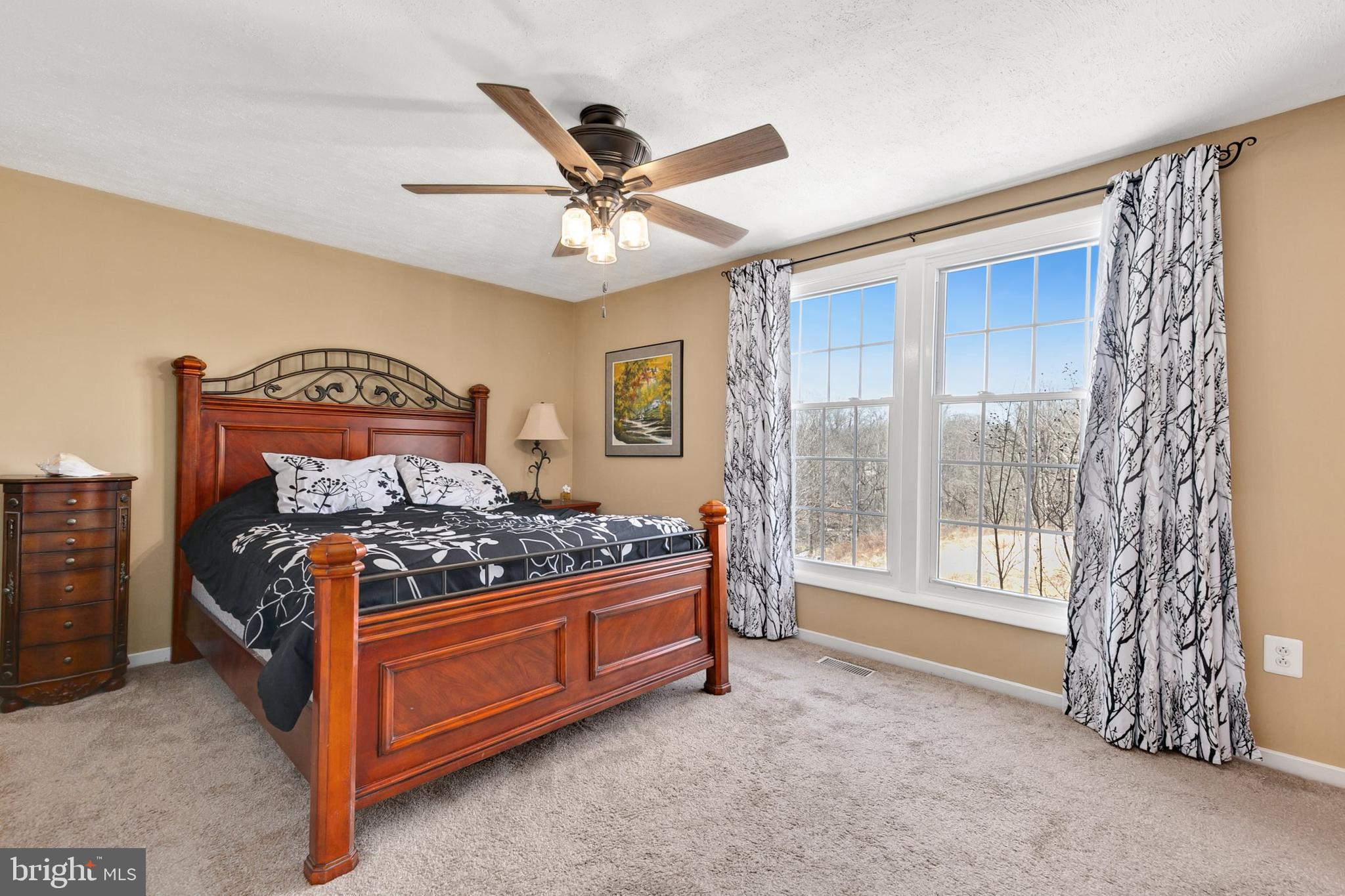 9348 Windbell Way Columbia, MD 21045 - Photo 15 of 37 a bed room with a bed and a window