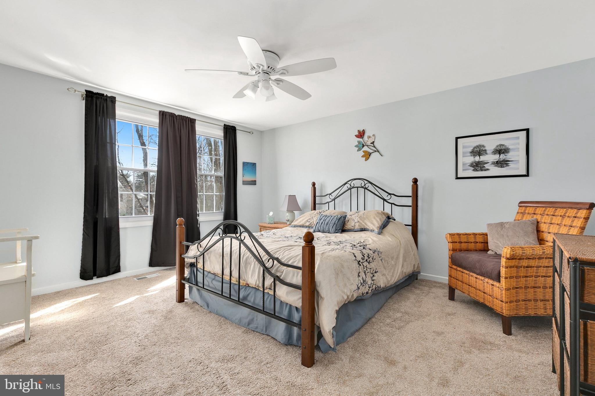 9348 Windbell Way Columbia, MD 21045 - Photo 17 of 37 a spacious bedroom with a bed and a chandelier