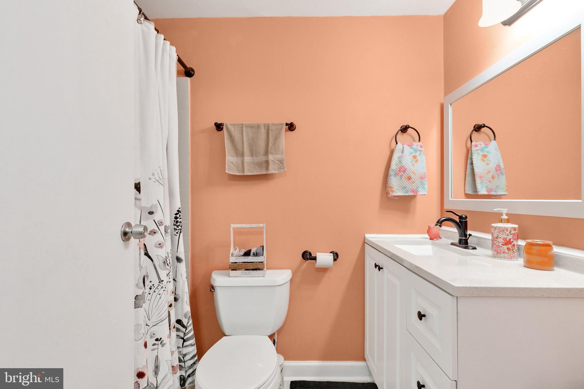9348 Windbell Way Columbia, MD 21045 - Photo 18 of 37 a bathroom with a toilet sink and mirror