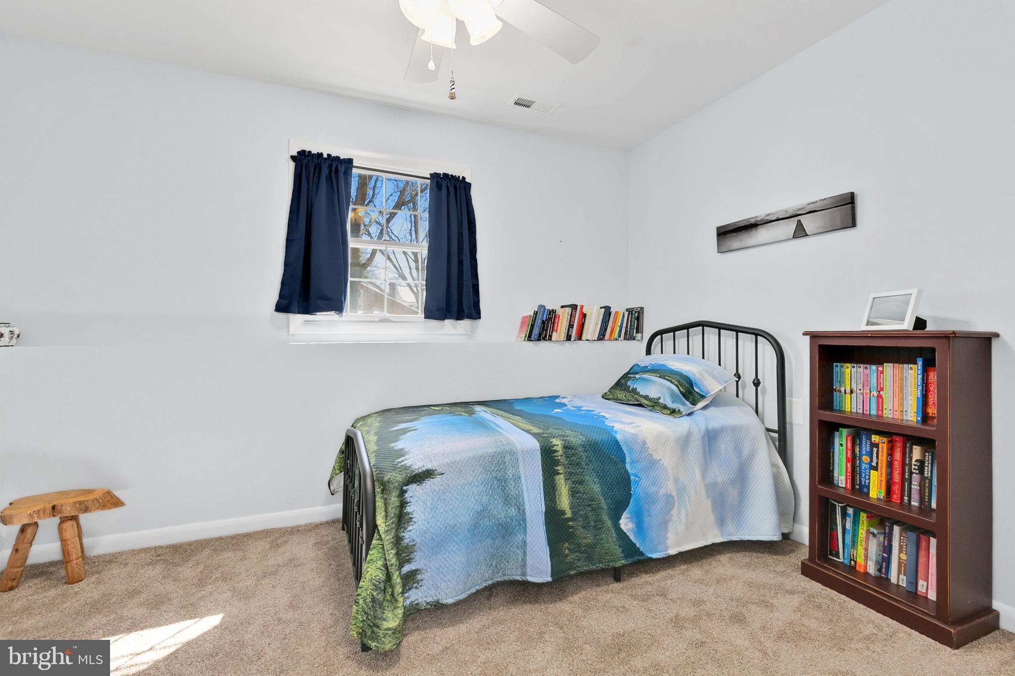 9348 Windbell Way Columbia, MD 21045 - Photo 23 of 37 a bedroom with bed and a book shelf