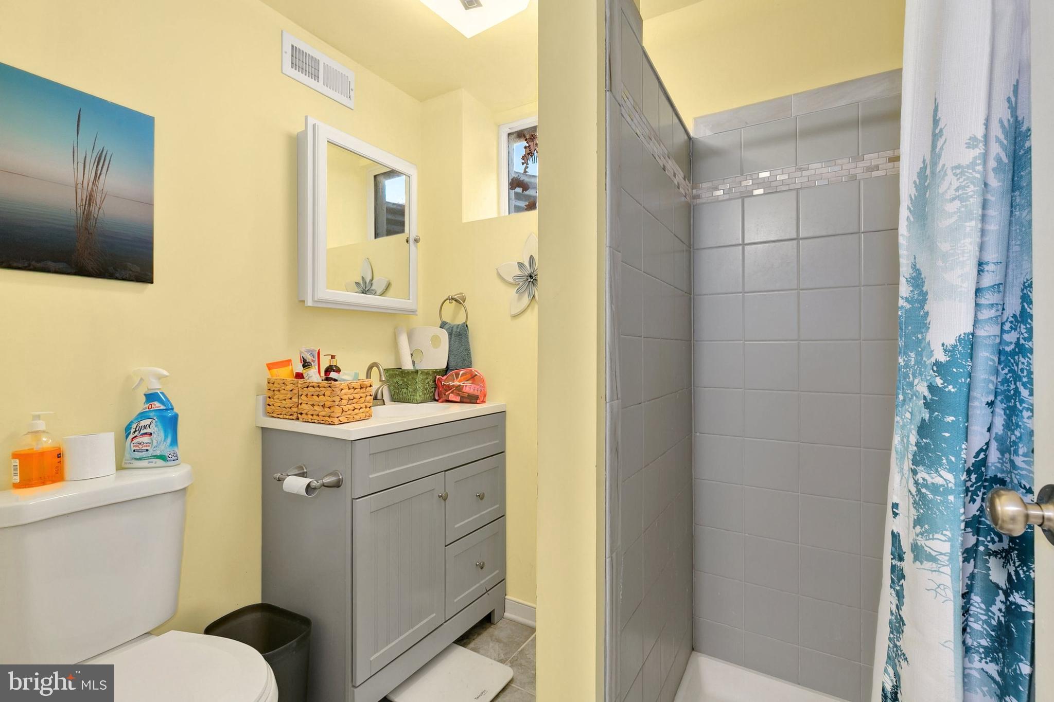 9348 Windbell Way Columbia, MD 21045 - Photo 27 of 37 a bathroom with a sink toilet vanity and shower