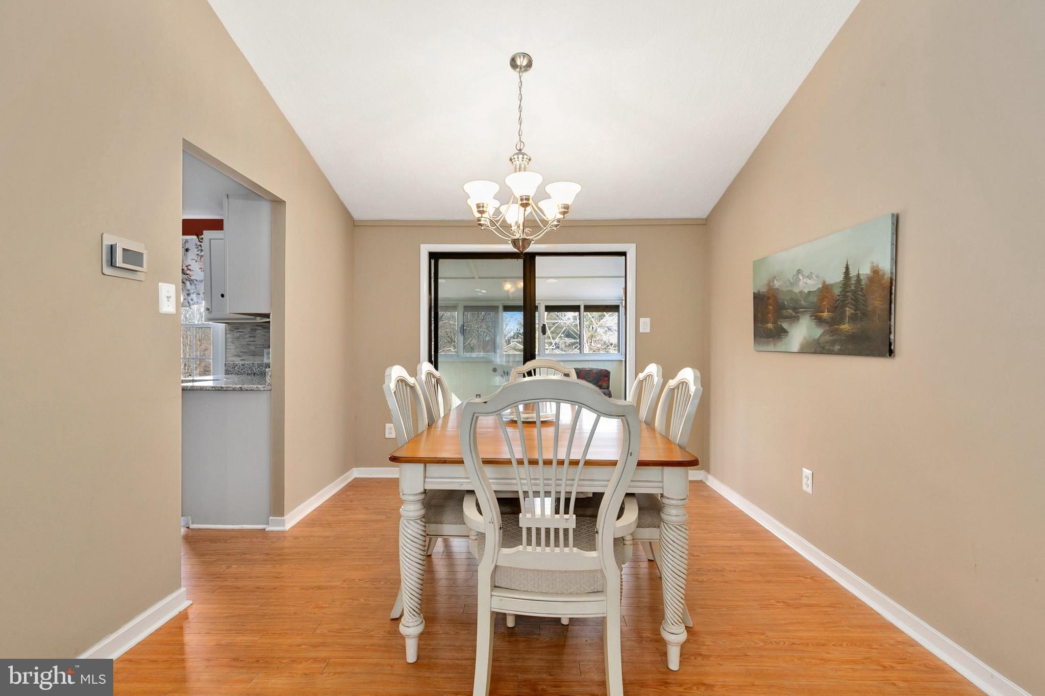 9348 Windbell Way Columbia, MD 21045 - Photo 7 of 37 a view of a dining room with furniture a chandelier and wooden floor